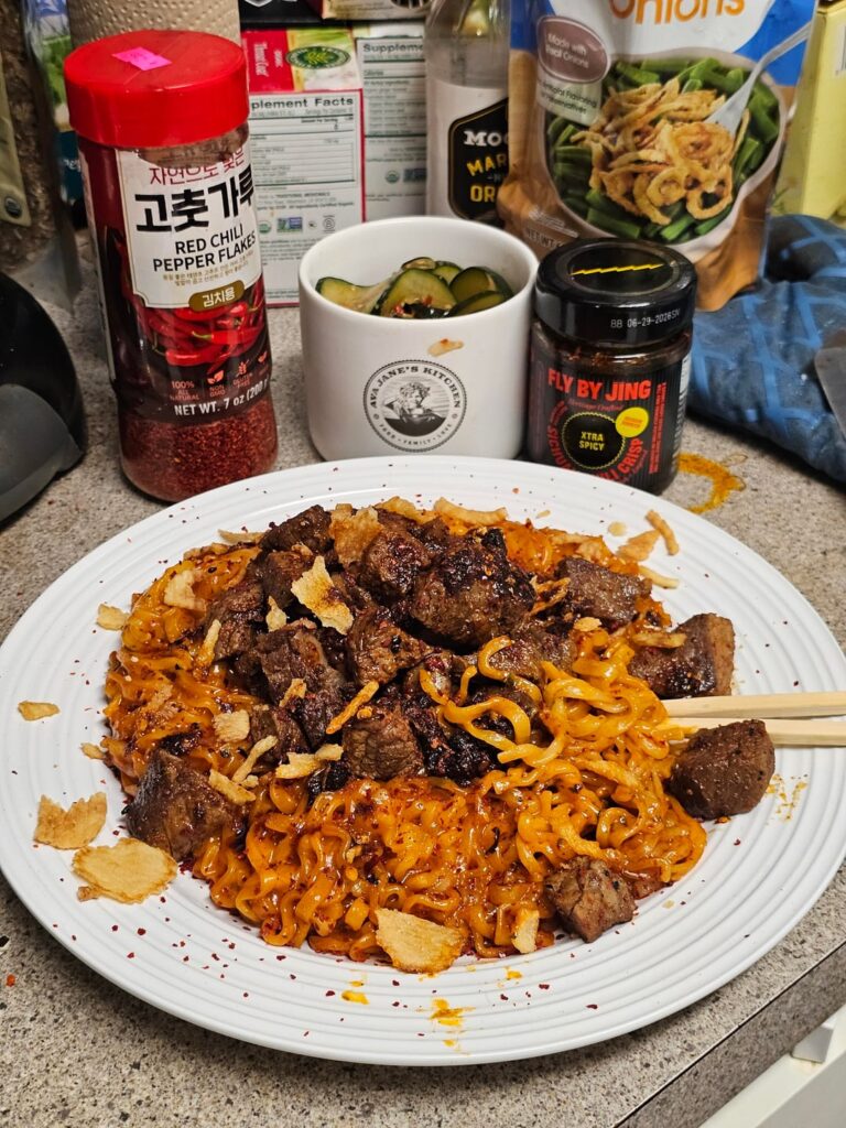 Buldak 2x + Carbonara, leftover ribeye/sirloin, Fly By Jin, fresh garlic, mushrooms, fried onions, and chili pepper flakes. I... am in heaven, my friends.