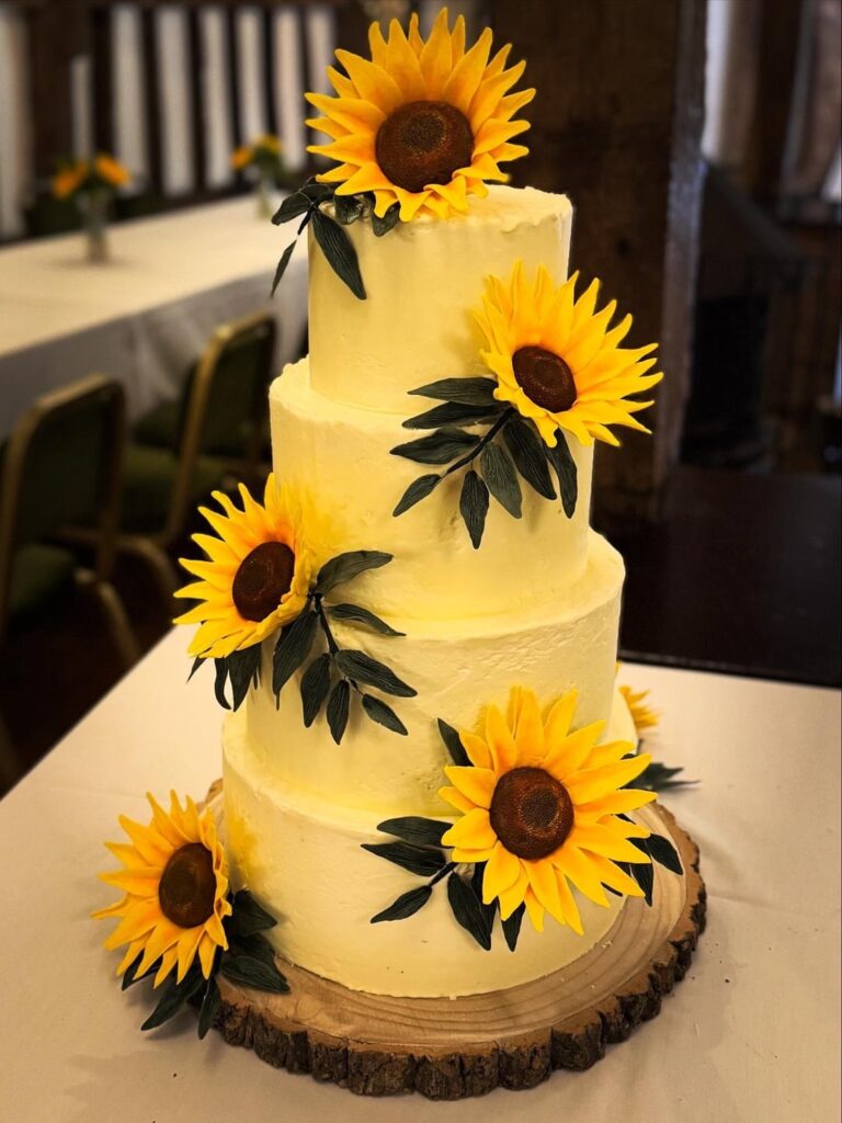 Sugarcraft sunflowers on a red plaid wedding cake