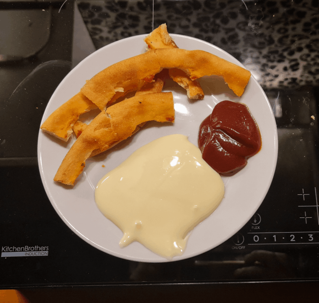 Stale pizza crust with cheese and bbq sauce