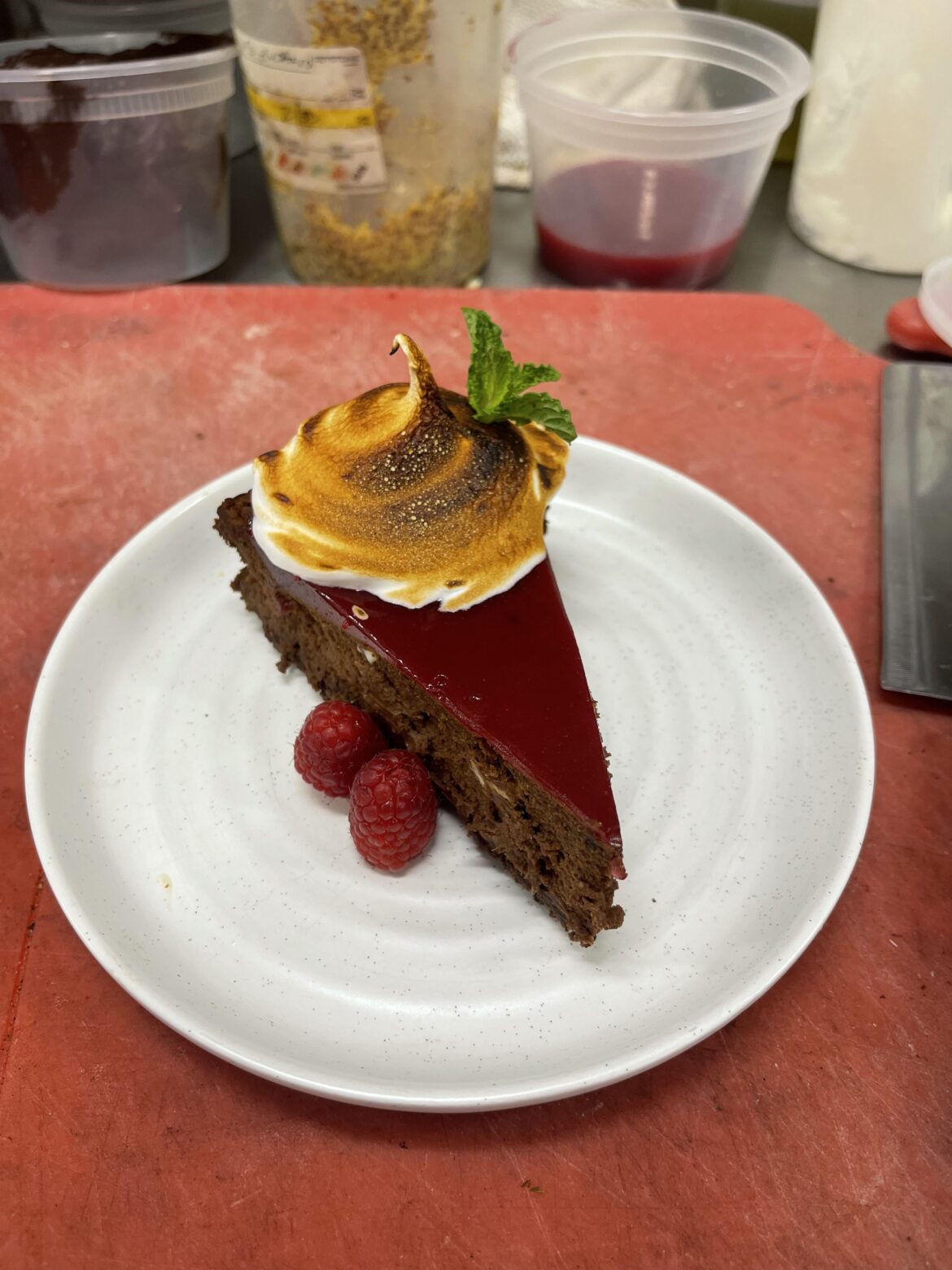 Chocolate cheesecake with raspberry gelée & toasted Italian meringue.