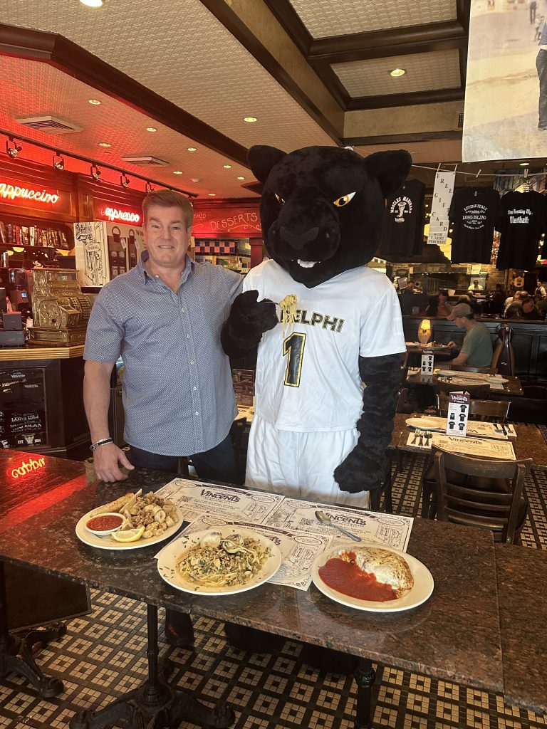 Vincent's Clam Bar owner with the Adelphi University mascot.