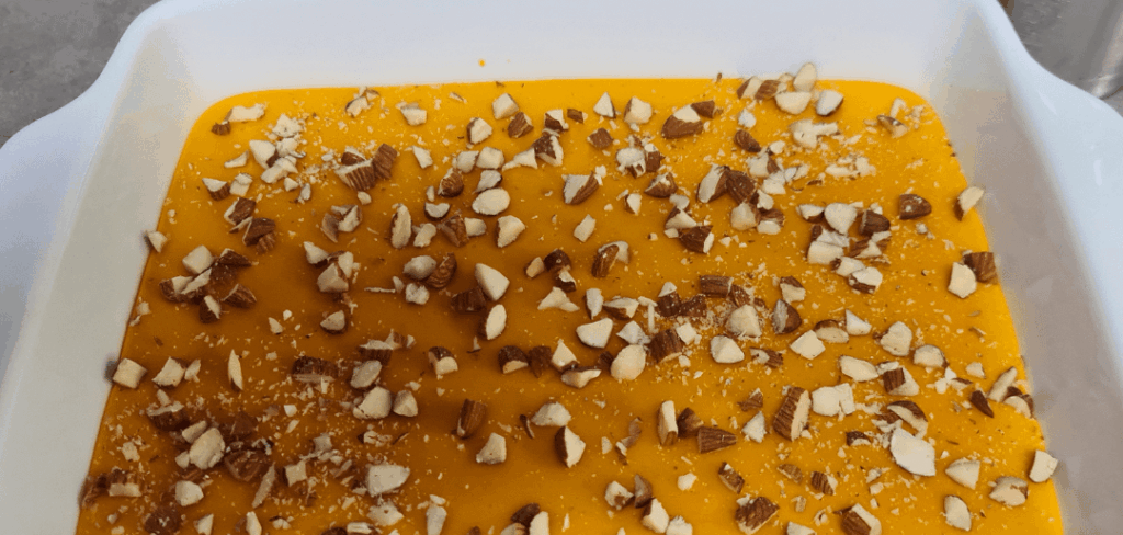 Pumpkin pie with almond topping and a drizzle of honey