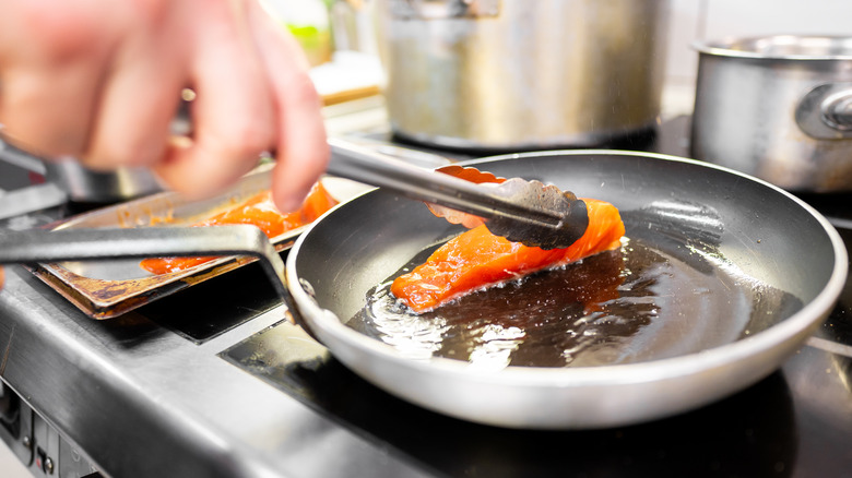 Frying salmon in skillet