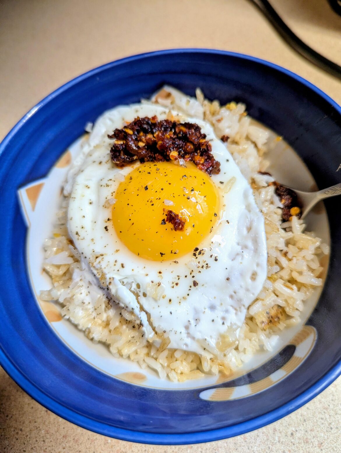 Put a Sunny Side Up Egg on leftover takeout rice with ghee and soy sauce