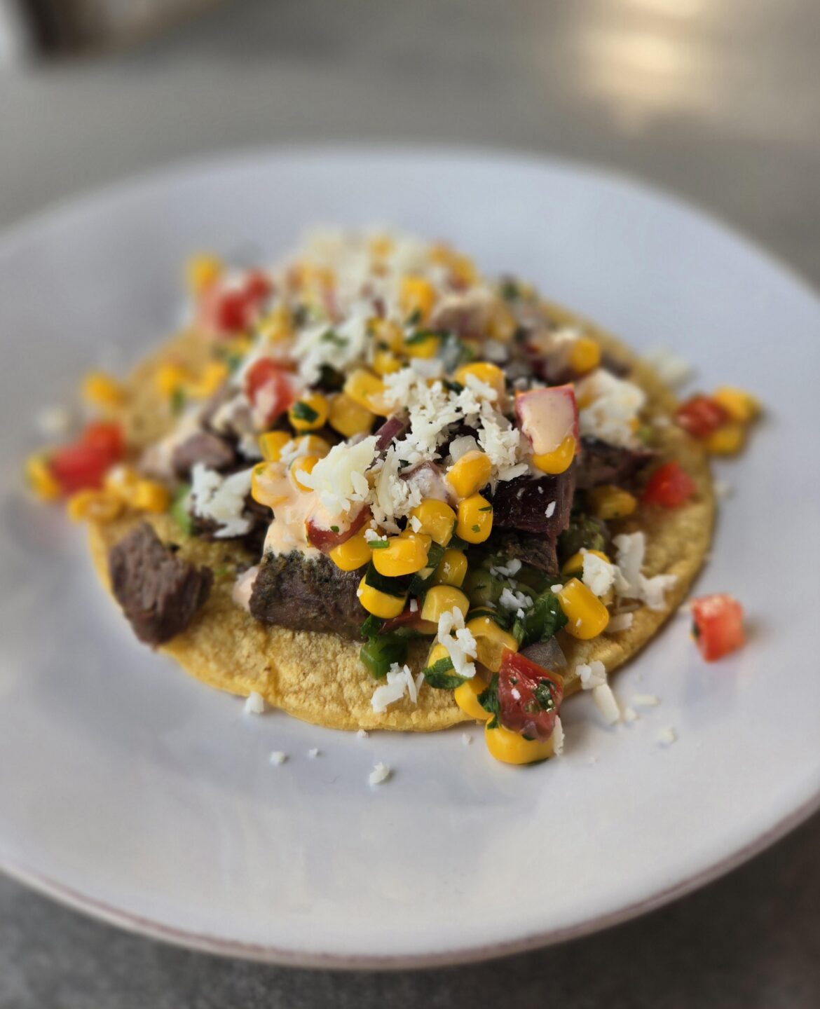 Carne asada, corn "salsa", cotija and chipotle crema