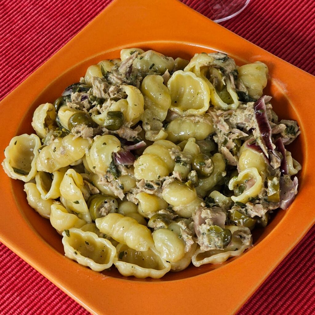 Pasta, simmered in a Mediterranean-inspired sauce (made of onions sautéed in butter, tuna, olives, capers, sage fresh from the garden, and cream to your taste)