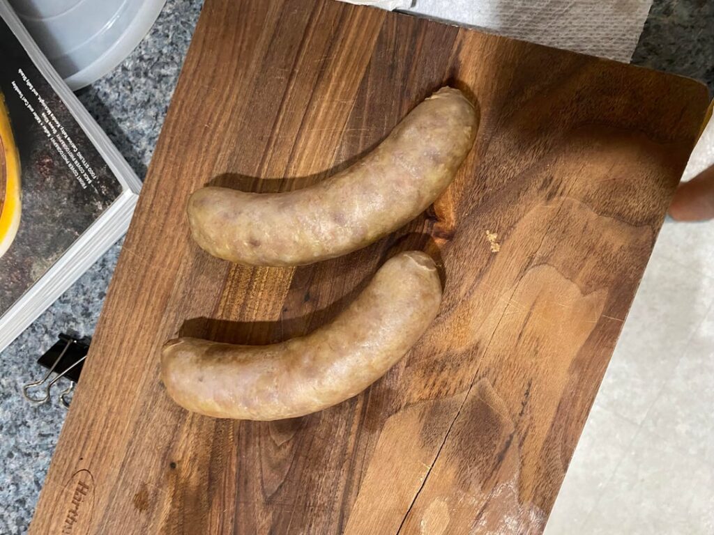 Beer braised bratwurst with sautéd with onions and green peppers Beer braised bratwurst with sautéd with onions and green peppers