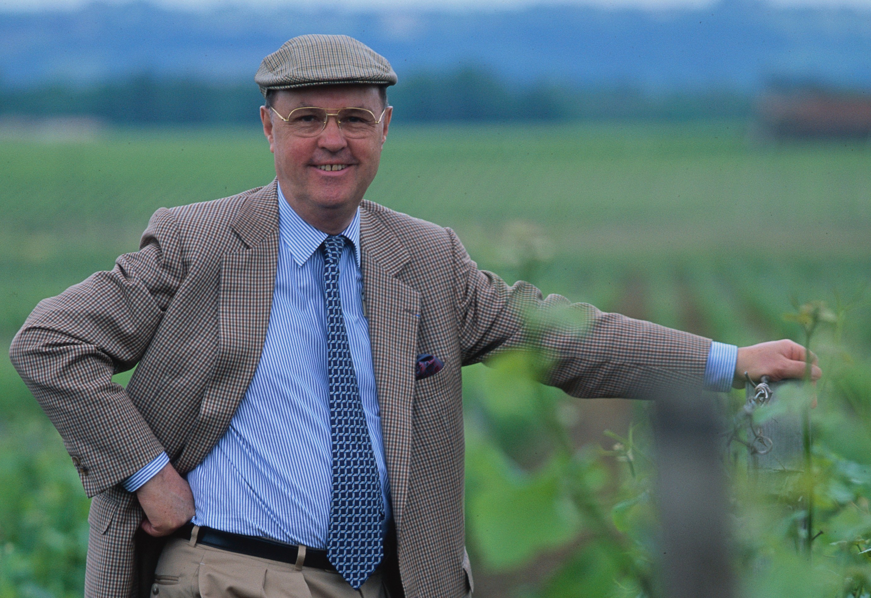 Count Alexandre de Lur Saluces stands in a vineyard.