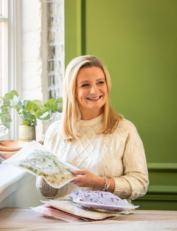 A photo of Suzanne Mulholland with prepped and frozen foods
