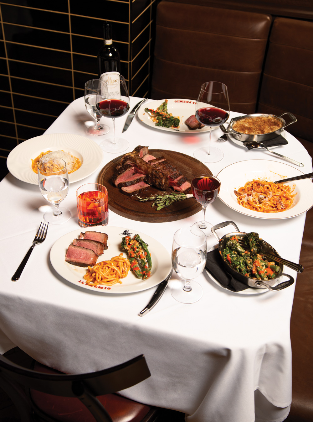 Wagyu beef tartare and a bit of bread, and a spread of bistecca alla Fiorentina, pastas, and broccolini.