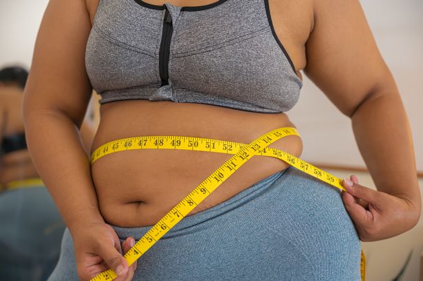 Person measuring their waist