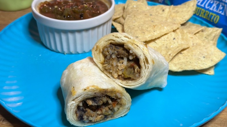 Sprouts fajita chicken burrito on blue plate with chips and salsa