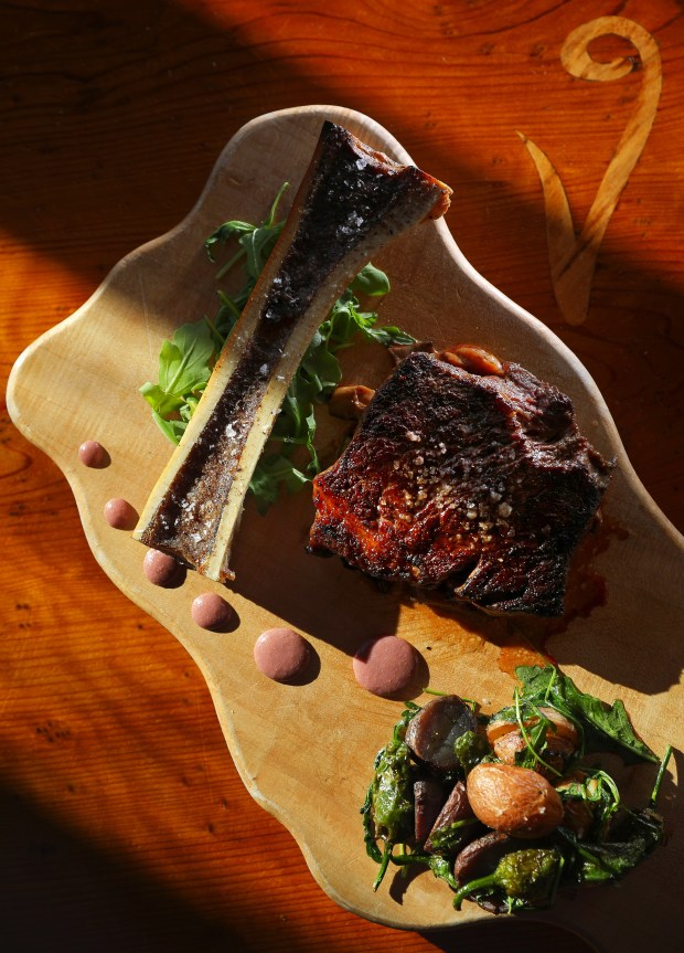 Peppercorn-crusted New York steak with wild mushroom fondue and roasted bone marrow, served with potato and pepper hash, by chef Dustin Valette at Valette, in Healdsburg. (Christopher Chung / The Press Democrat)