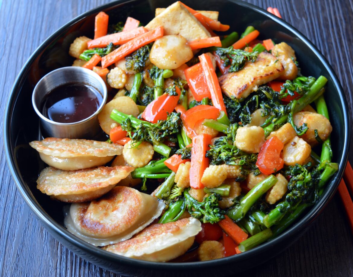 487 cal. Tofu dumplings with tofu and vegetable stir fry with sesame ginger sauce.