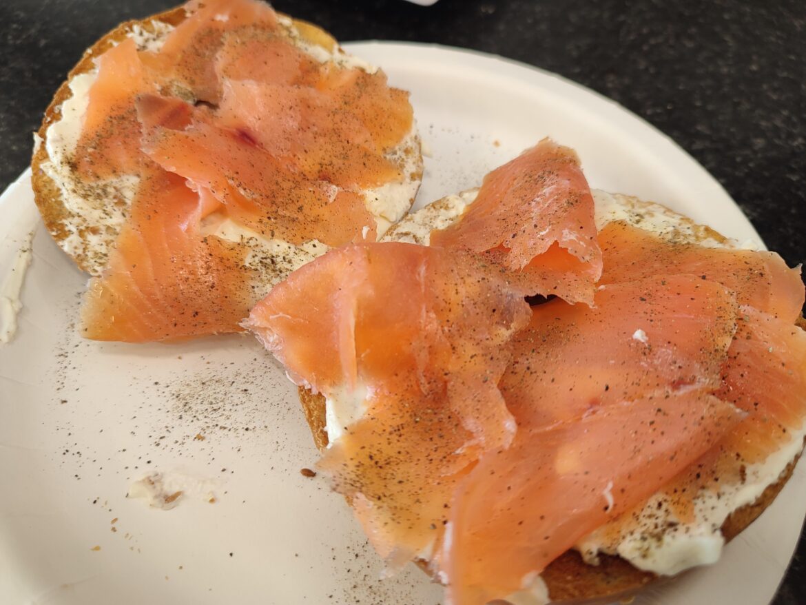 Smoked salmon and cream cheese bagel on a paper plate because it's at work