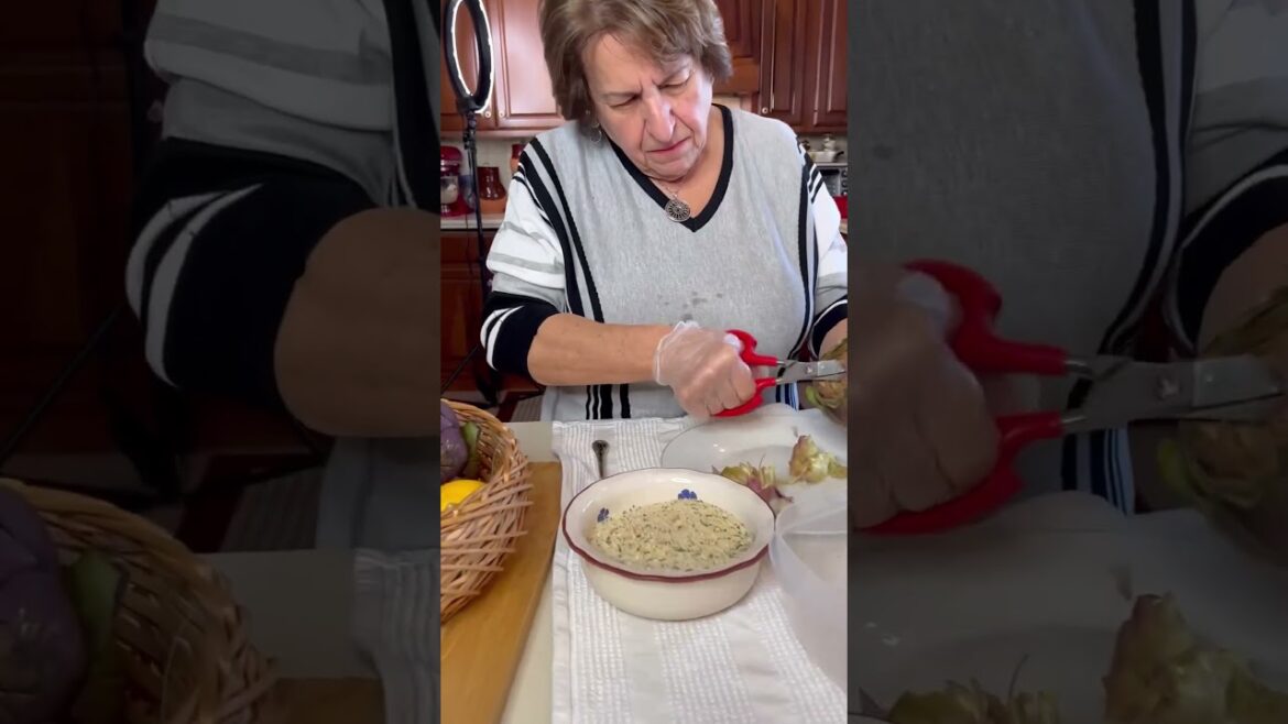 Nonna preps large artichokes for stuffing, trims inside with scissors ✂️ & slams to open them up