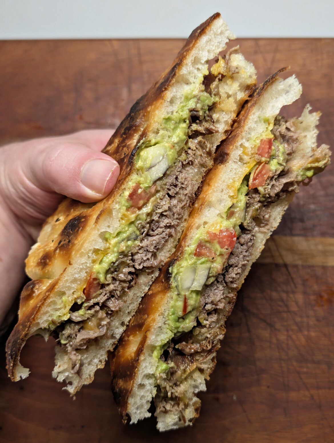 [homemade] steak, guacamole, mayo, cheddar on sourdough focaccia