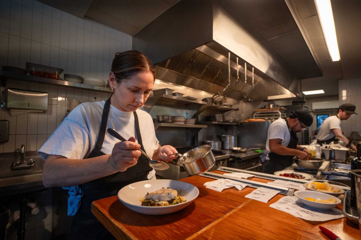 Austin readies for 2025 Michelin Guide restaurants reveal Chef Tracy Malechek-Ezekiel prepares rockfish with summer squash, shishito, beurre blanc, capers, and parsley at Birdie's in Austin, Oct. 9, 2024. The counter-service style restaurant is also a contender for a star on Tuesday.