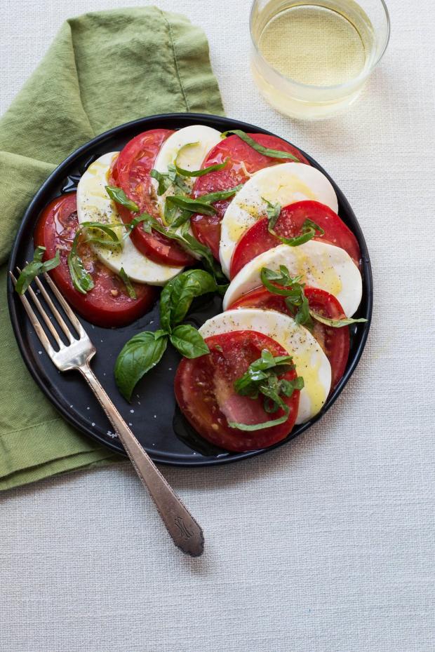 A dish of caprese salad, made with tomatoes, basil, olive oil and mozzarella, is displayed in New York on Aug. 17, 2017. (Cheyenne M. Cohen via AP)