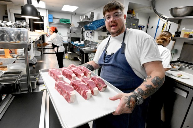 Fortezza Ristorante chef Dylan Rigolini shows the ribeye steaks available...