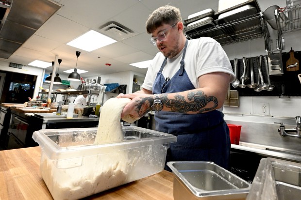 Fortezza chef Dylan Rigolini works with the bread dough on...