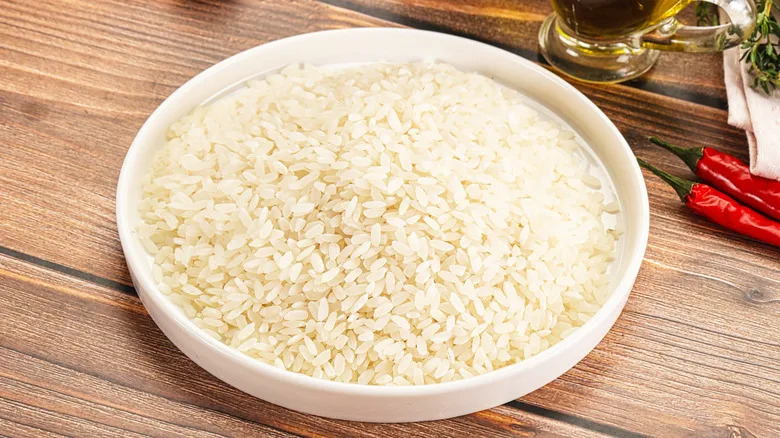 Dry Arborio rice on white plate