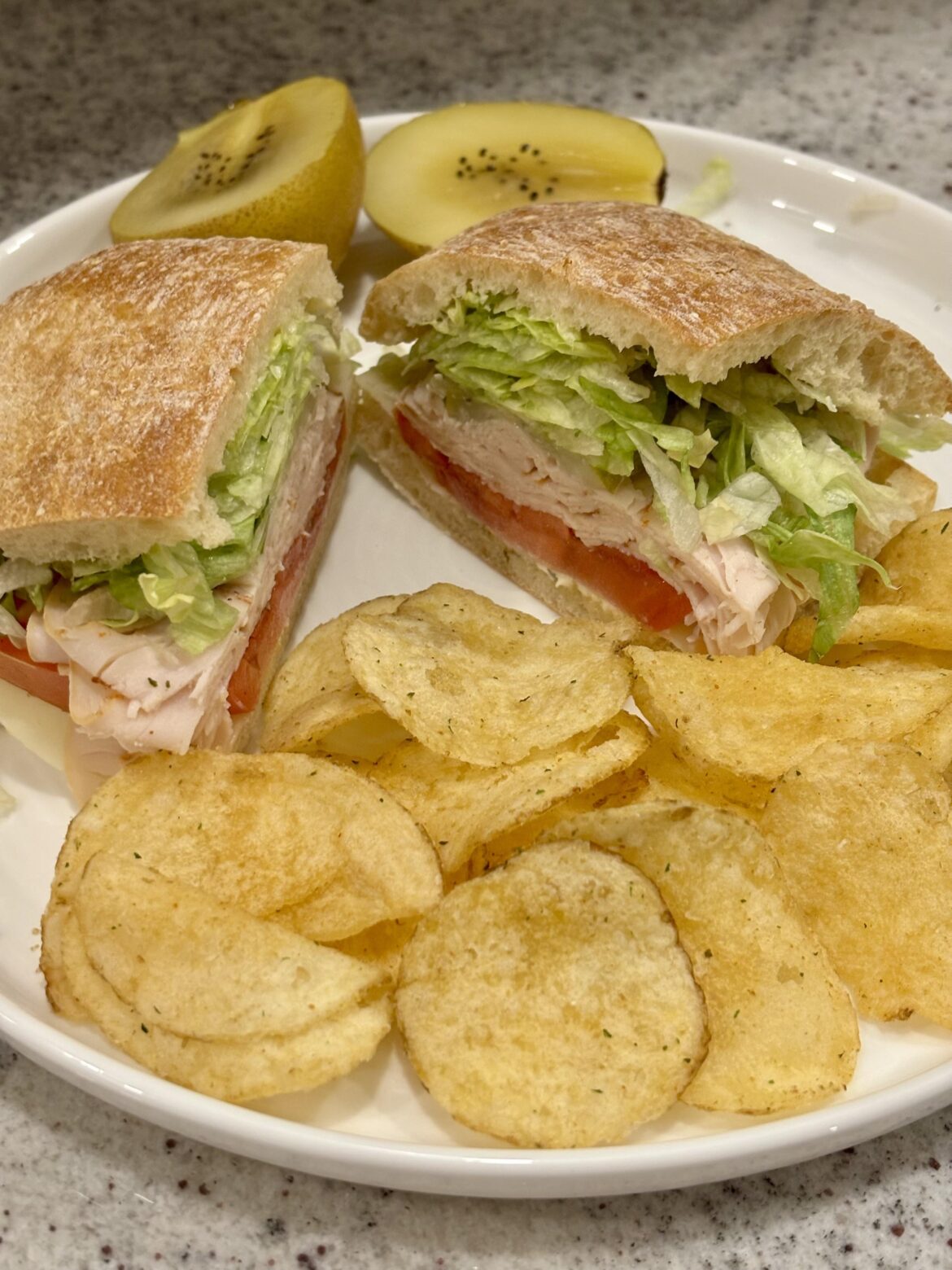 Turkey, provolone, mayo, sandwich dressing, tomato, lettuce, pickles, cracked black pepper and oregano on ciabatta.