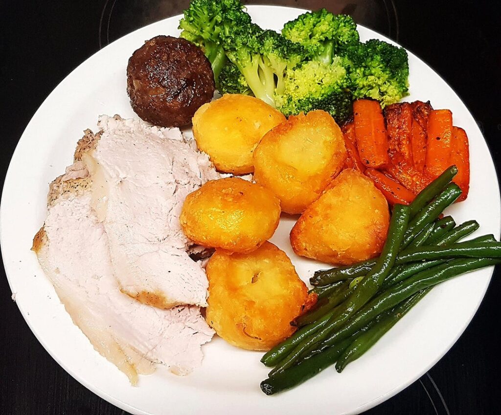 Sunday Roast Pork, Roast Potatoes, Sausage, Black Pudding and Pear Stuffing, Honey Carrots, Buttery Greens and Cider Gravy. Pear Sauce.
