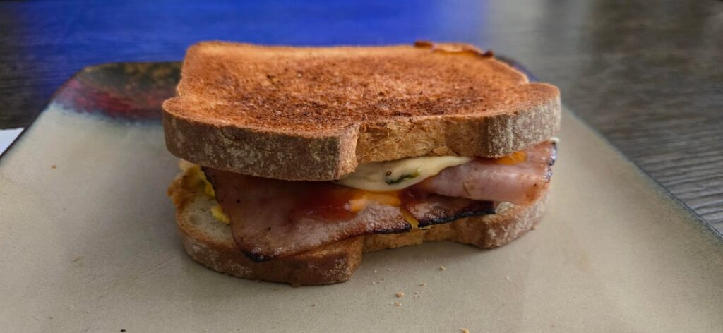 Ham, plant based cheese. Egg and spicy sauce.