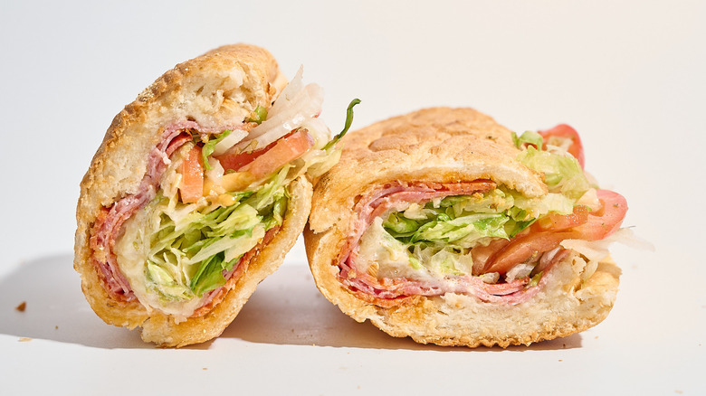 Potbelly Italian sandwich sliced in half on a white table