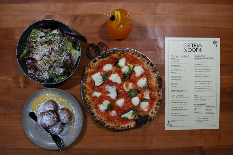 Margherita pizza, salad DOP, zeppole with lemon curd and a strega sula spiaggia cocktail at Osteria DOP in Eugene, October 9, 2025.