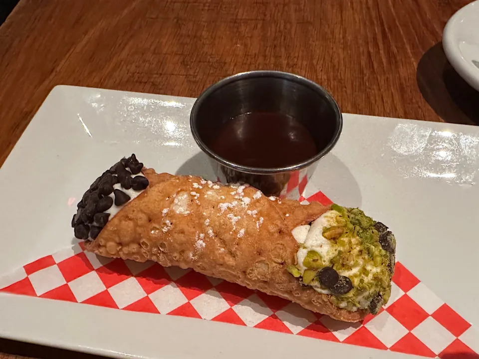 Cannoli with pistachio, chocolate on edges with dipping sauce at Buddy V's