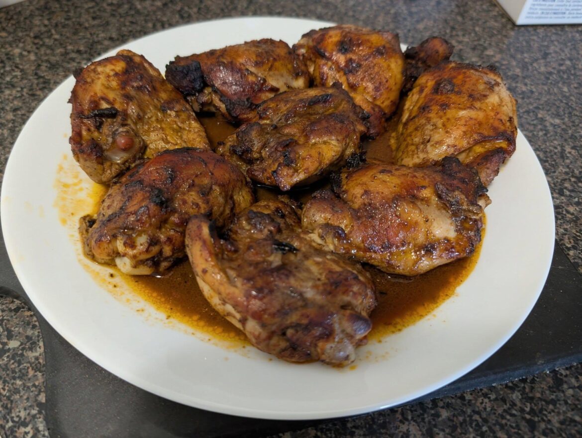 Chicken thighs in a tandoori marinade cooling off in their own juices.