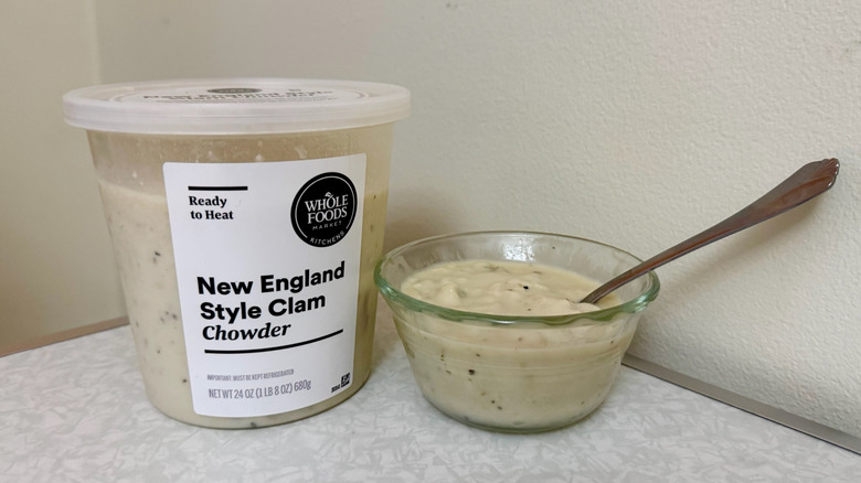 A tub and small glass bowl filled with New England Style Clam Chowder
