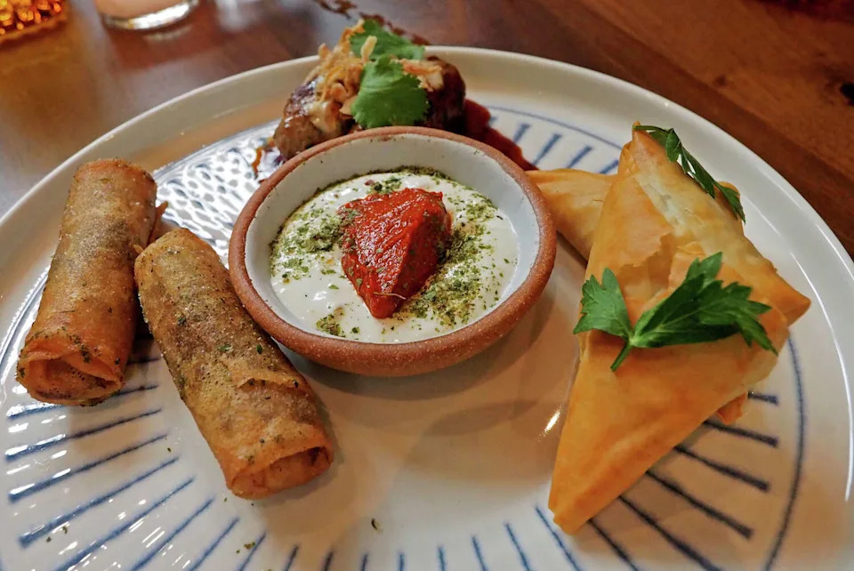 Appetizers offered at Dandelion, a restaurant that operates independently of Delamar Westport, in Westport, Conn., on Wednesday October 8, 2025. Clockwise from left to right is Moroccan Cigars, Roasted Sheftalia and Dandelion Spanikopita. (Christian Abraham/Hearst Connecticut Media)