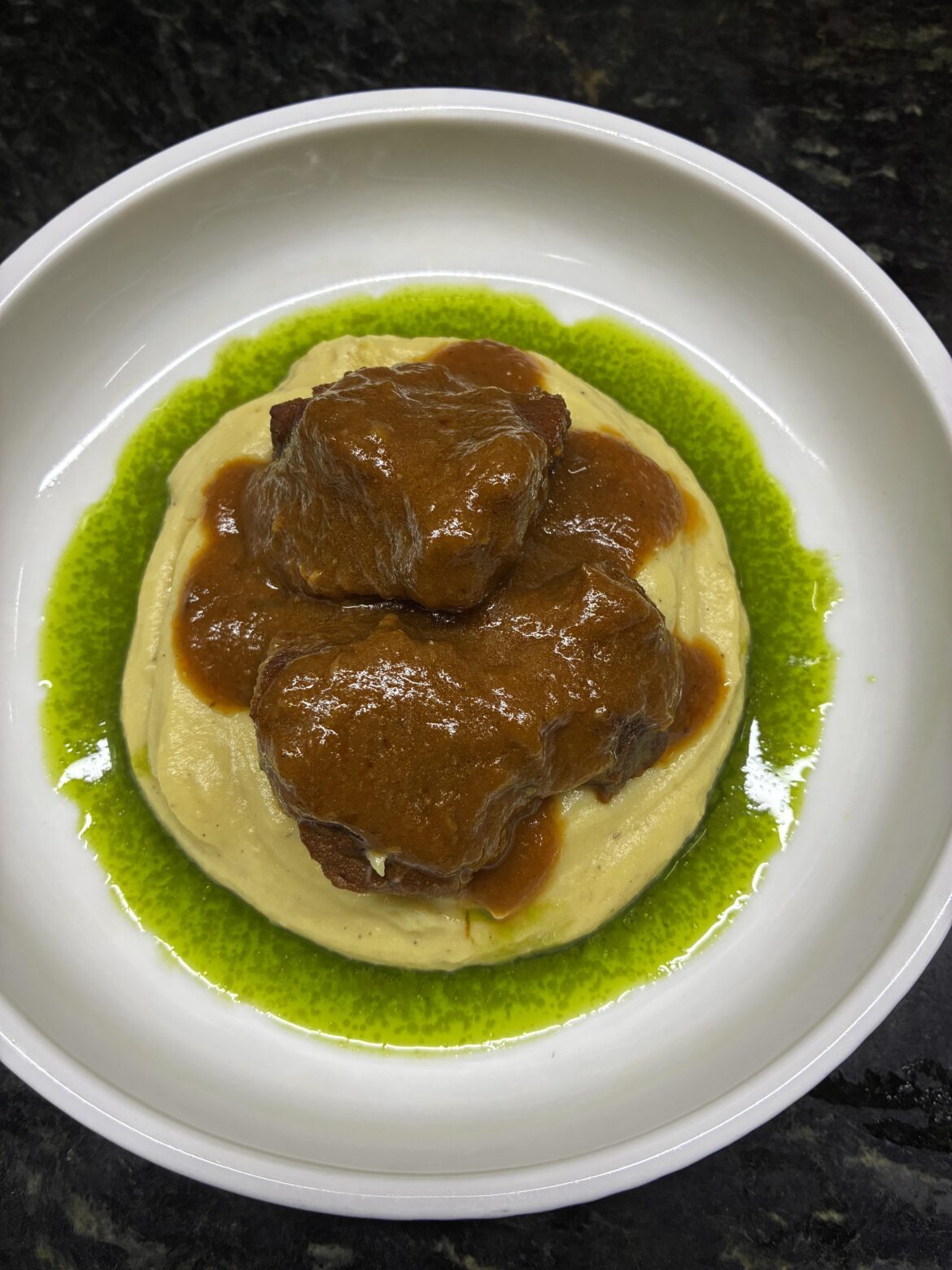 Braised beef, herb oil, smashed potato