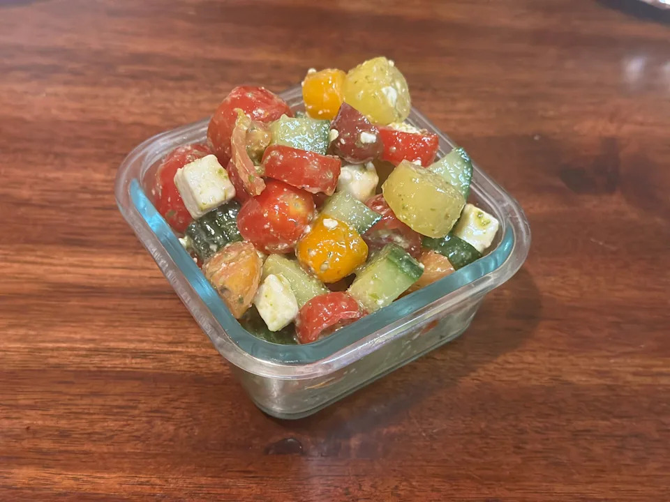 Tomatoes, cucumbers, feta salad in glass container