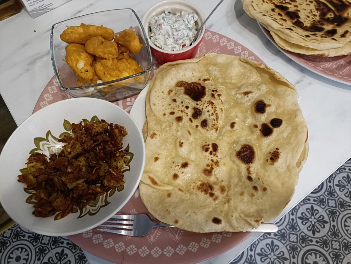 Indian/mexican fusion. Masala battered haddock, onion bhaji and raite in naan tortillas.
