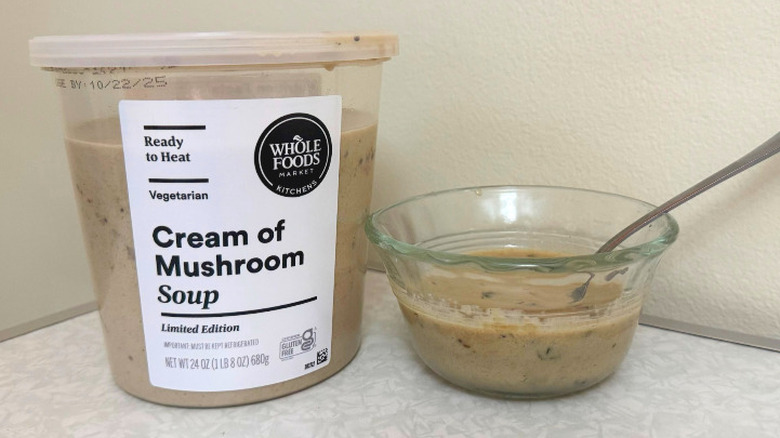 A tub and small glass bowl filled with Cream of Mushroom Soup