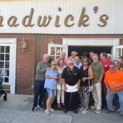 Roy DeLorenzo, Chadwick’s management and customers pose for the camera. Photo by Wayne Daren Schneiderman
