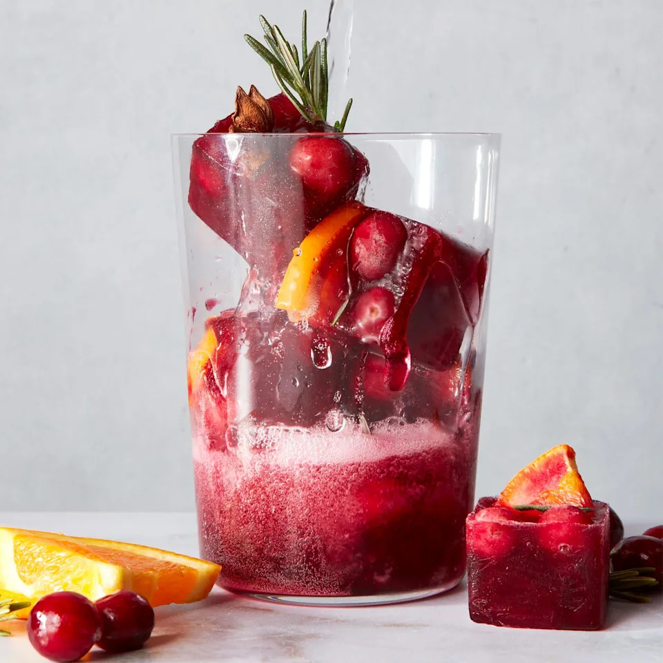 red frozen ice cubes with orange slices and spices