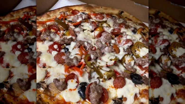 Close-up of a fully loaded pizza from Lee's Tavern in Staten Island, NYC