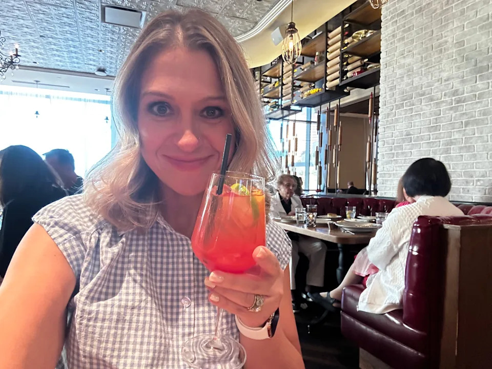 Author Terri Peters holding nonalcoholic spritz