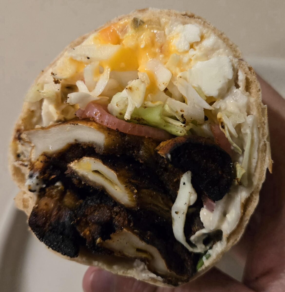 Grilled King Oyster Mushroom "Shawarama" with Tahini Cream, Saffron Mayo, Feta, Pickled Red Onions, Green Cabbage, and Mint