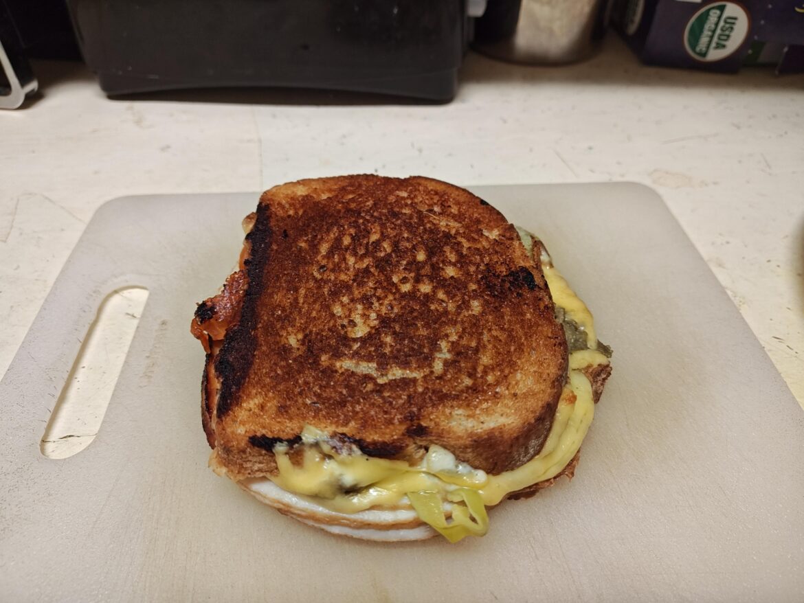 Turkey, cheddar, butter, mayo, tomato, pickles, peperoncini, guacamole; grilled