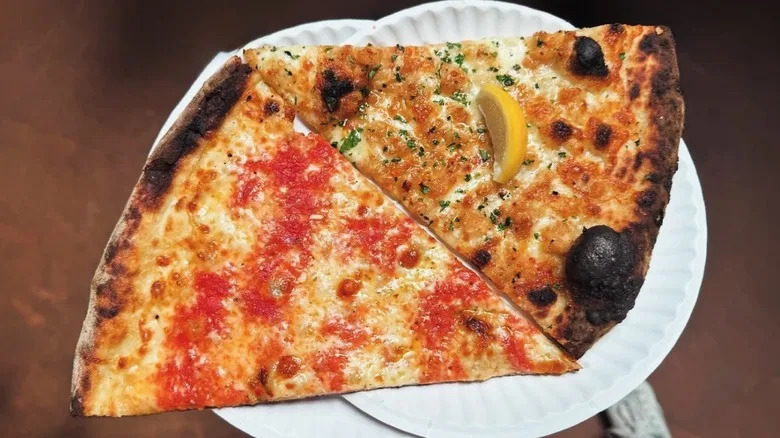 Two slices of pizza on paper plates from F & F Pizzeria in Brooklyn, NYC