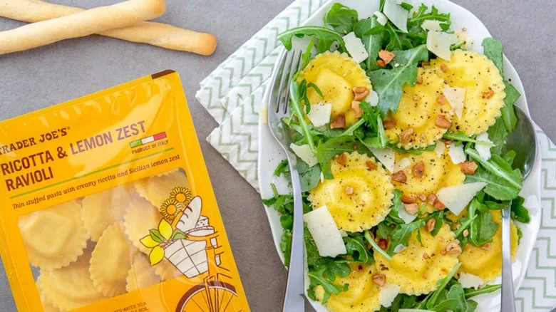 Trader Joe's ricotta & lemon zest ravioli in the package and prepared on a bed of arugula