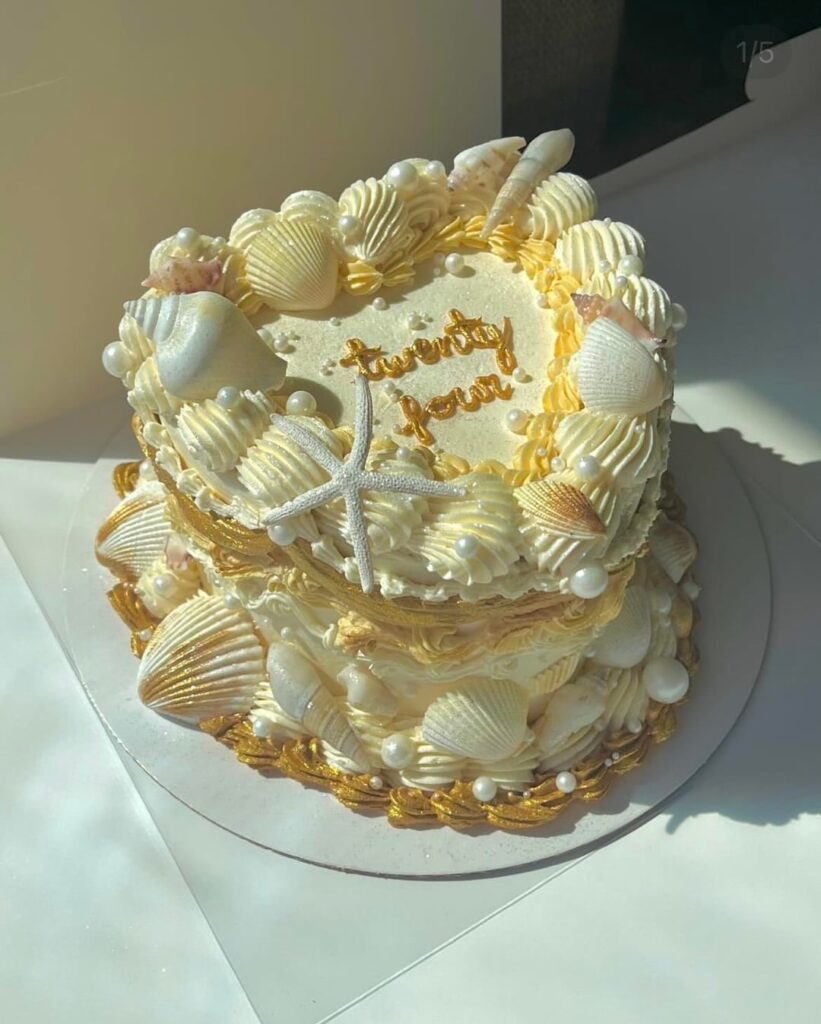 A gold seashell themed cake for a customer’s birthday!
