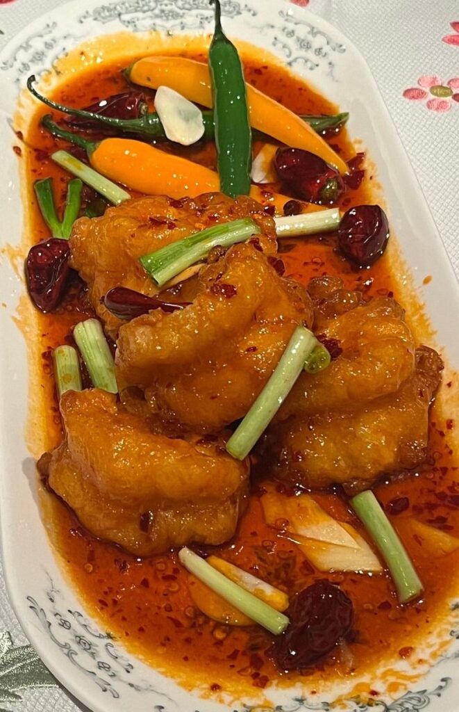 Fried shrimp, in sweet and sour sauce, with chili peppers.