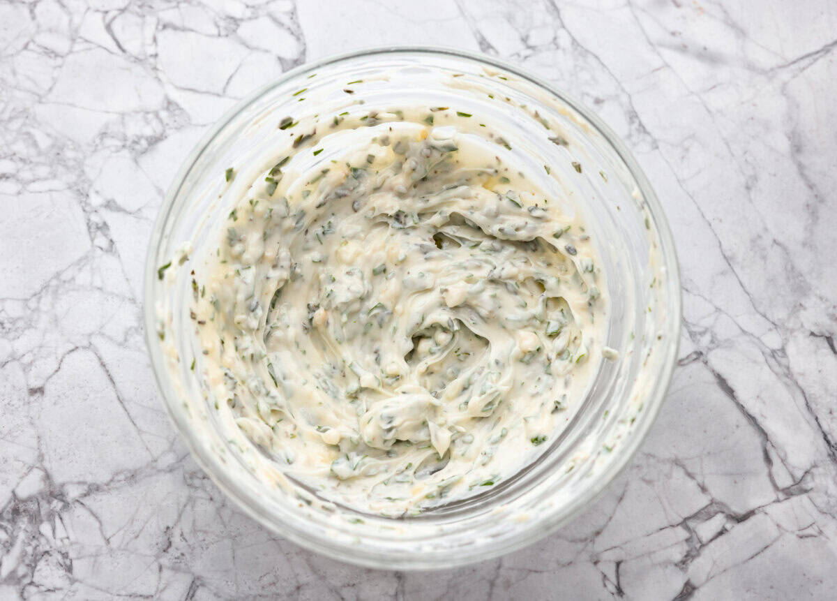 I’m not saying I’ve eaten half a loaf of this Garlic Bread straight off the baking sheet…but I’m also not not saying that. It’s golden, cheesy, dripping with garlicky butter, and so good! Garlic butter ingredients all mixed together in a bowl.